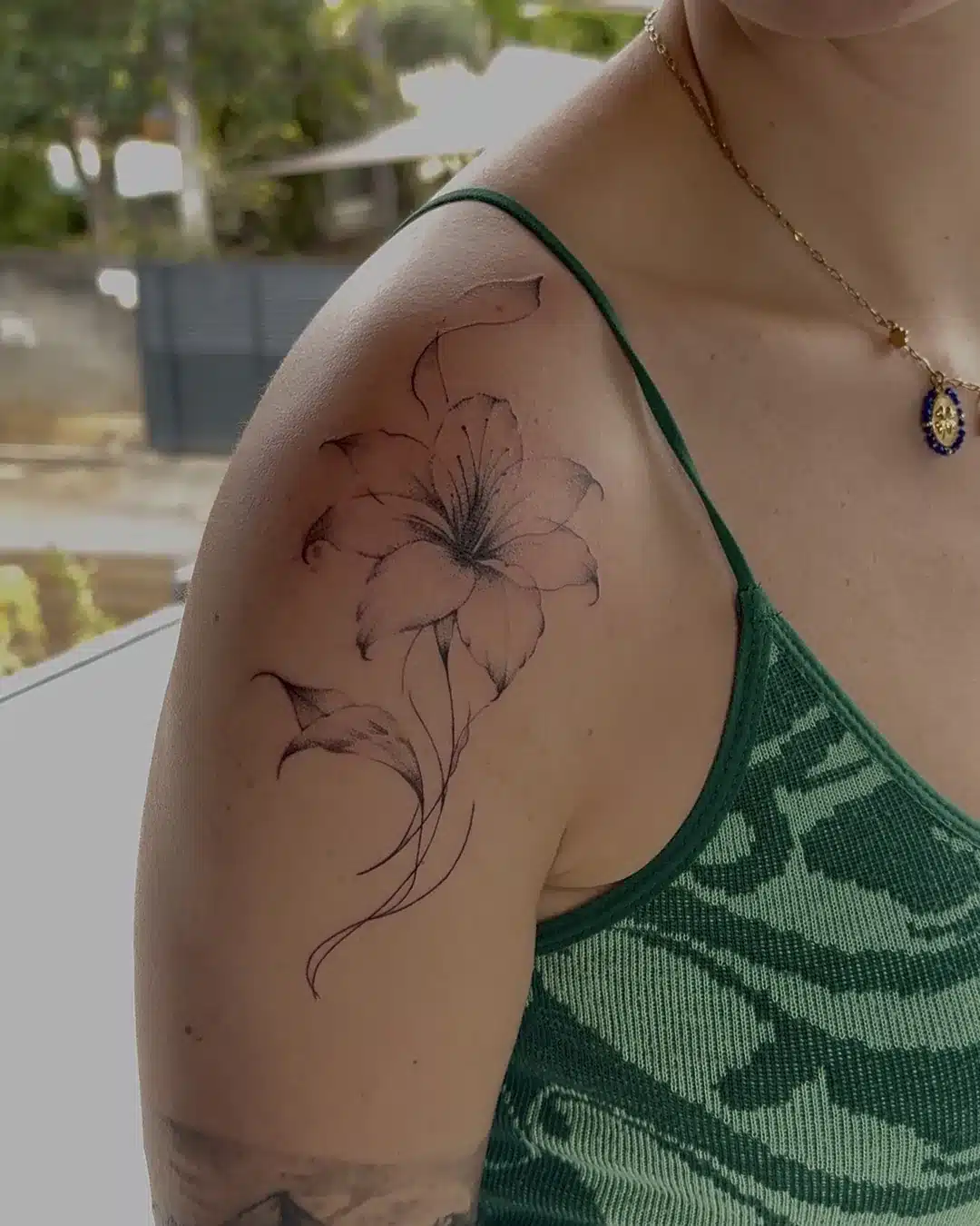 Tatouage fine line fleur de lys sur l'épaule – Jax Ink Tattoo, Saint-Gilles-les-Hauts